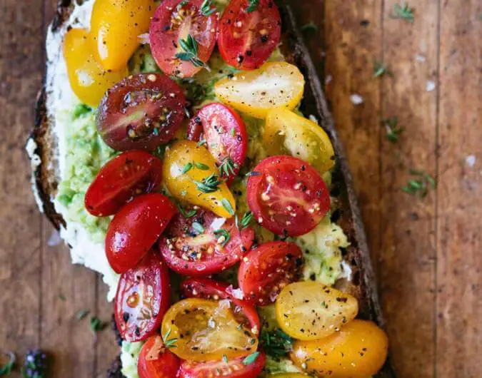 Loaded Avocado Toast Topped with Tomatoes, Thyme, and Ricotta